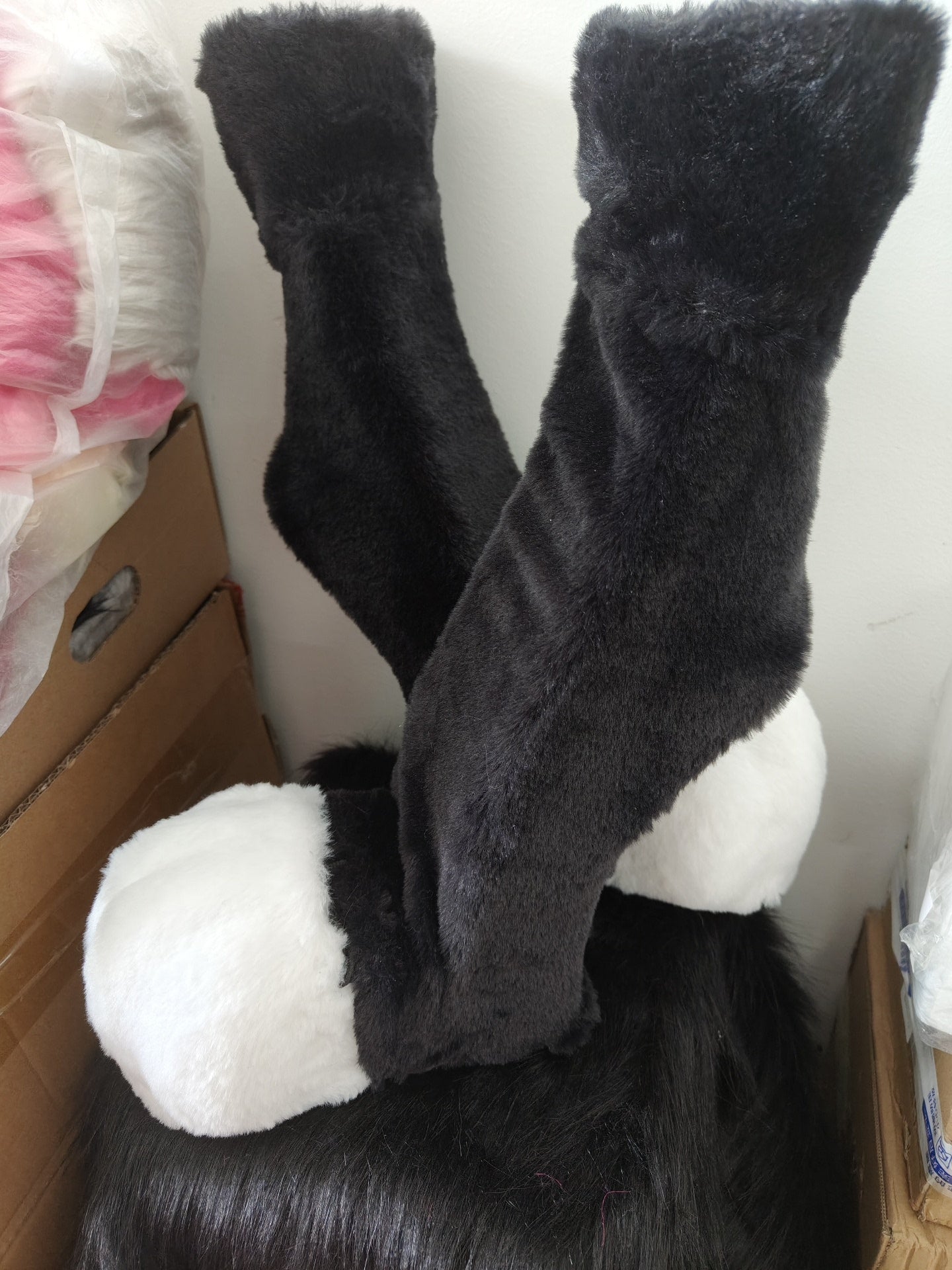 Furry black and white recurved legs and animal feet