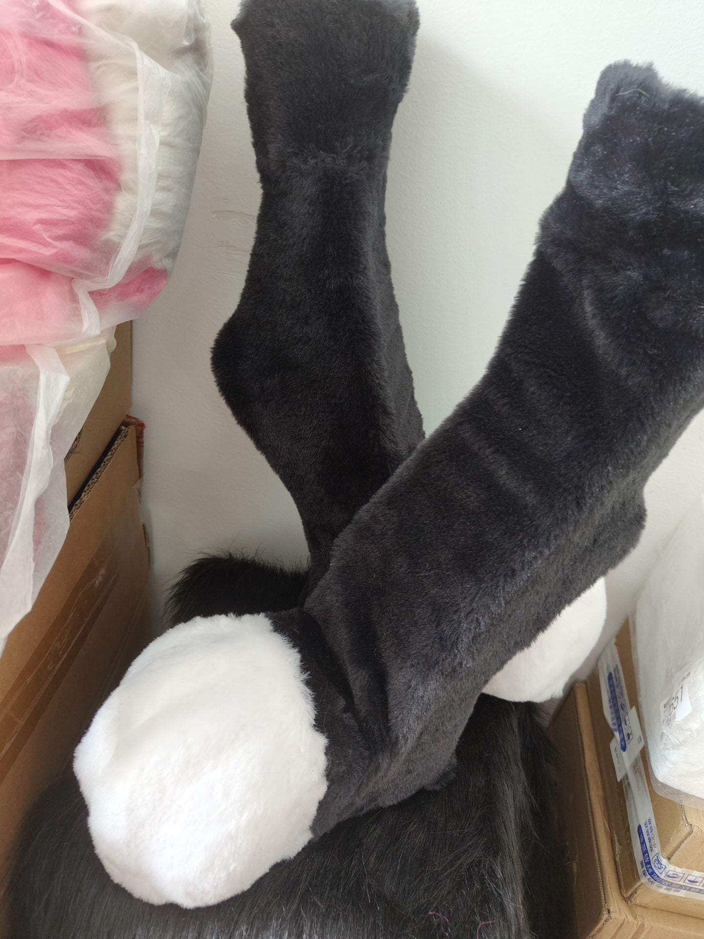 Furry black and white recurved legs and animal feet