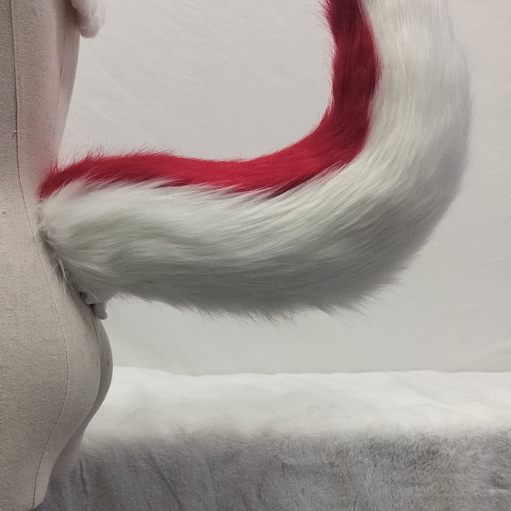 Pink and white tail simulation animal tail