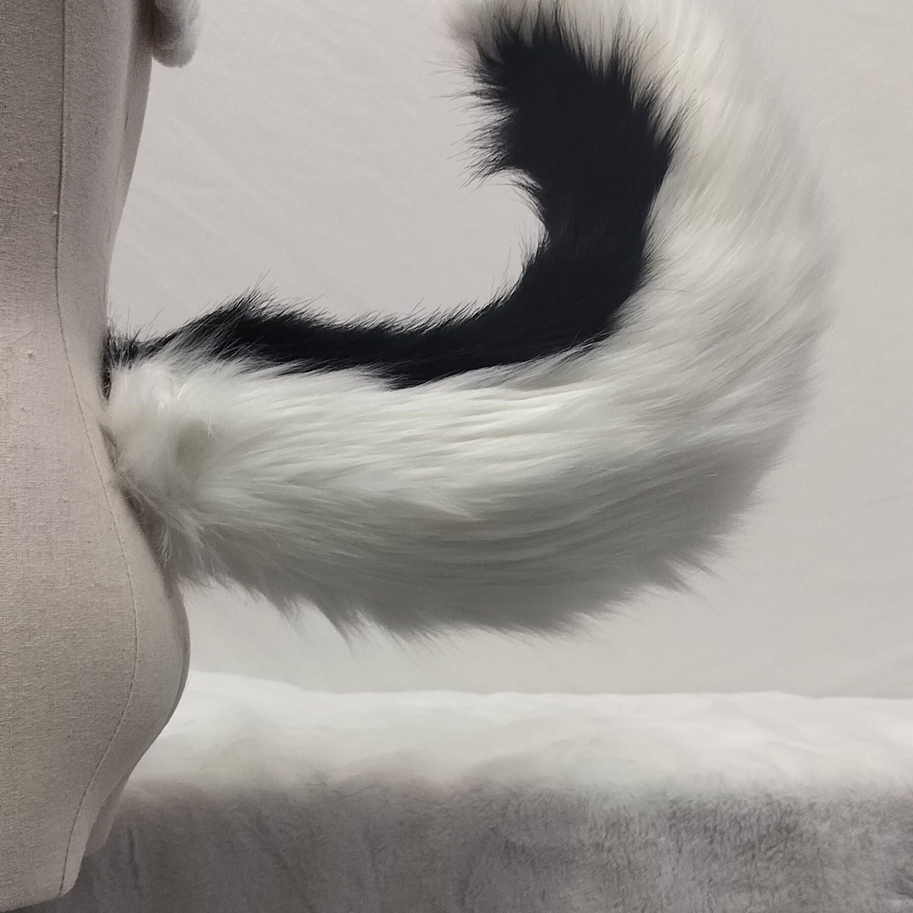 Pink and white tail simulation animal tail