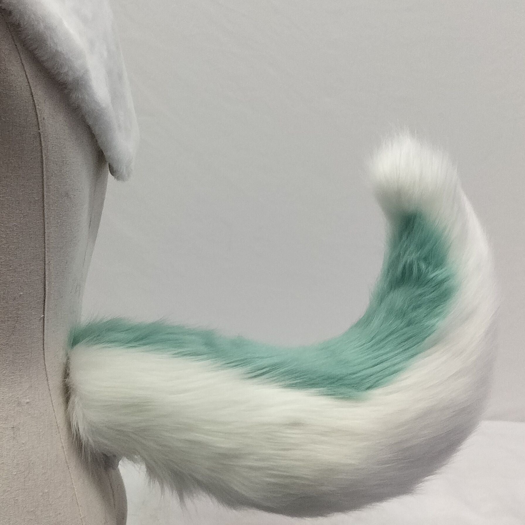 Pink and white tail simulation animal tail