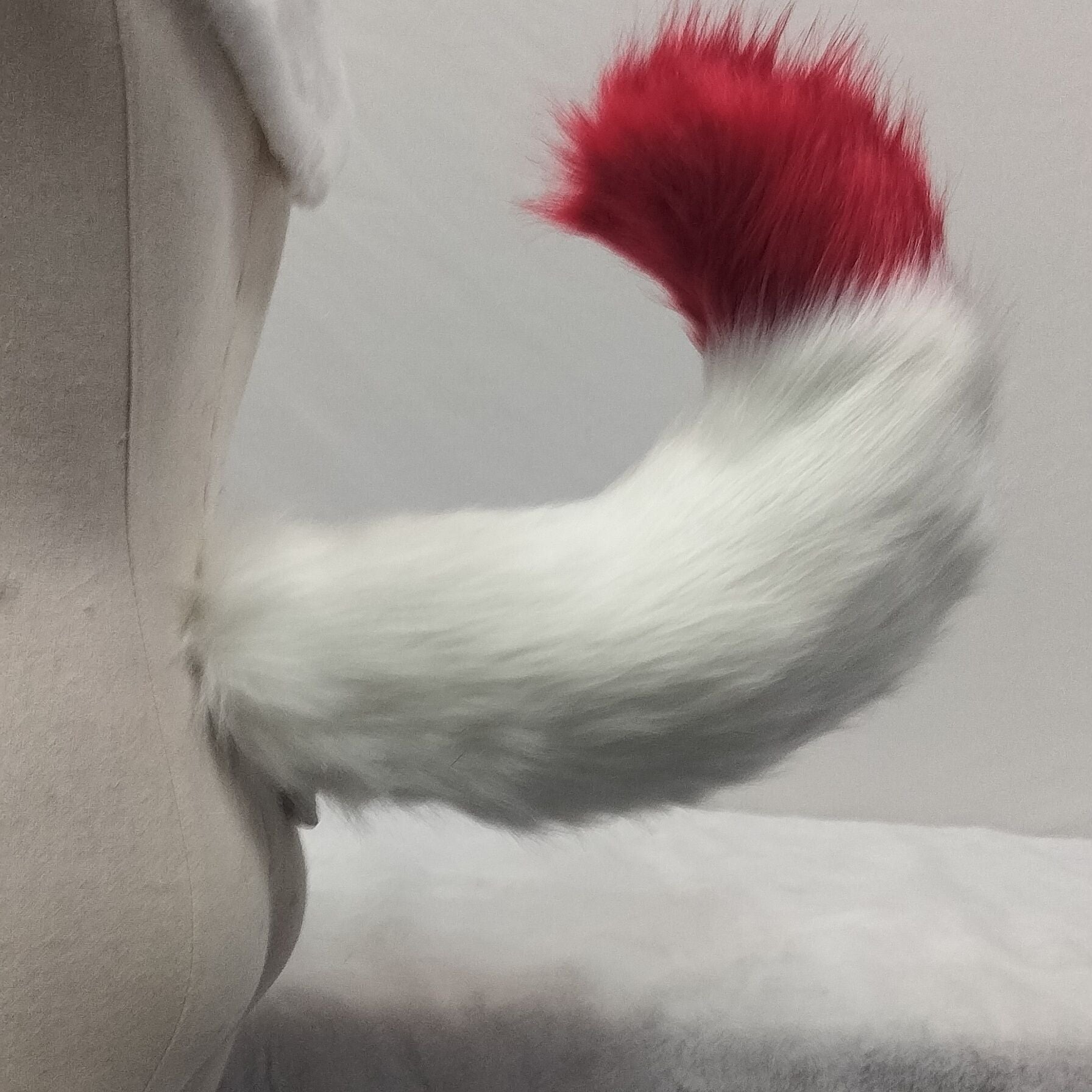 Pink and white tail simulation animal tail
